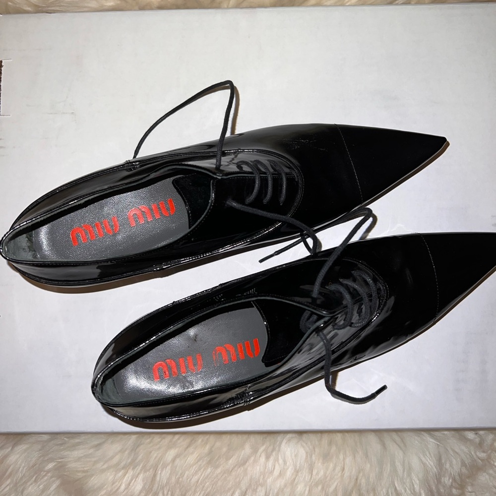 Miu Miu black oxford lace up pointed toe shoes. Have a small heel.